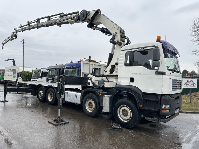 MAN TGA 35.430 8x2 + KRAN HIAB 700 E-6 + JIB 165X-3 - RETARDER - PRITSCHE 6m70~8m50 EXTENDABLE - MANUAL GEARBOX ZF - LIFT + STEERING AXLE - Camión caja abierta, Camión grúa: foto 1 MAN TGA 35.430 8x2 + KRAN HIAB 700 E-6 + JIB 165X-3 - RETARDER - PRITSCHE 6m70~8m50 EXTENDABLE - MANUAL GEARBOX ZF - LIFT + STEERING AXLE - Camión caja abierta, Camión grúa: foto 1